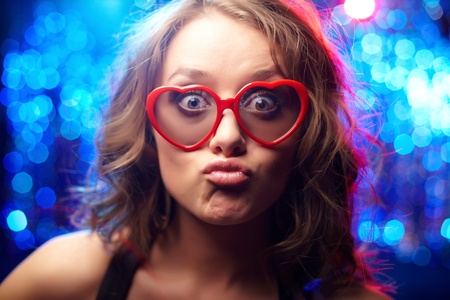 funny girl wearing heart-shaped glasses