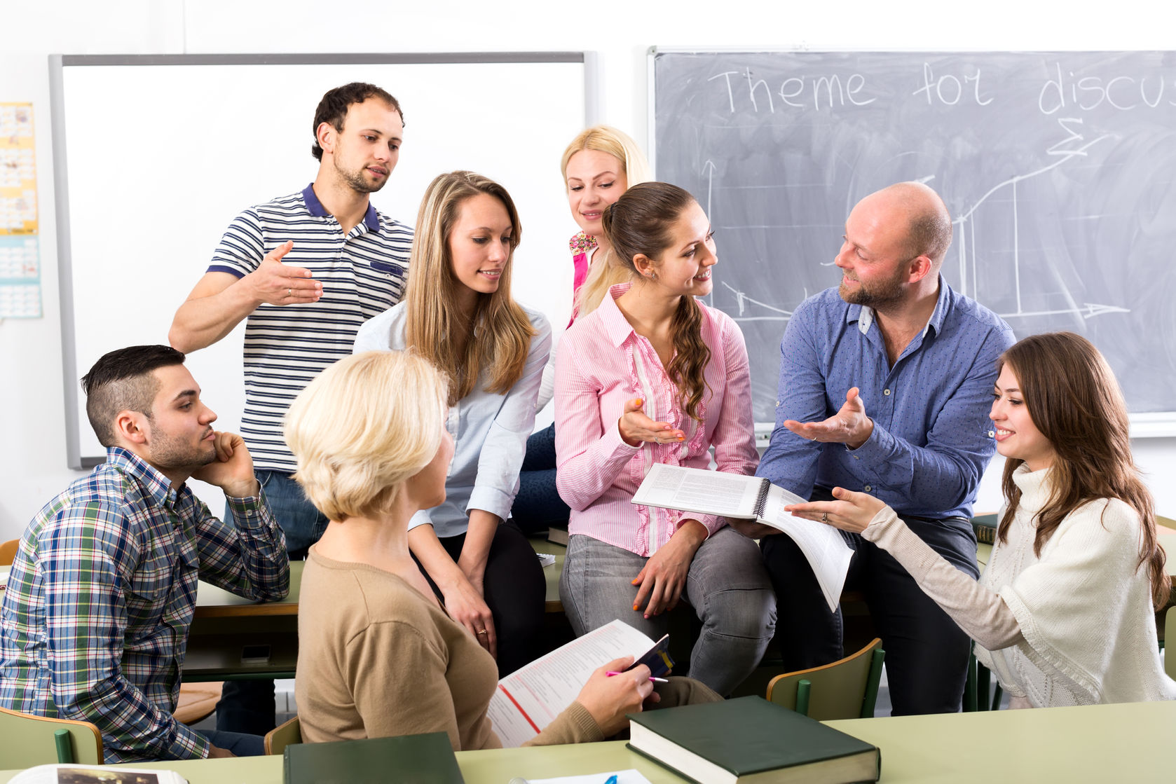 teacher having informal discussion with his graduate students during a break between subjects