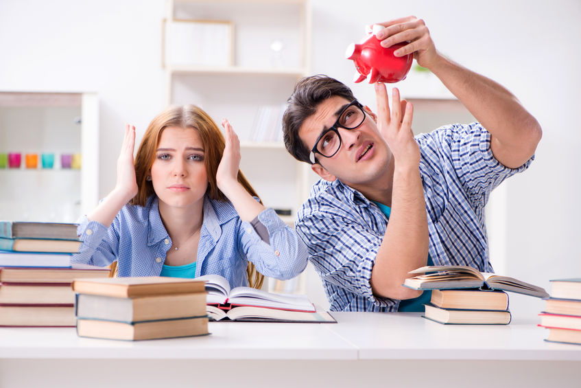 Two students checking savings to pay for education